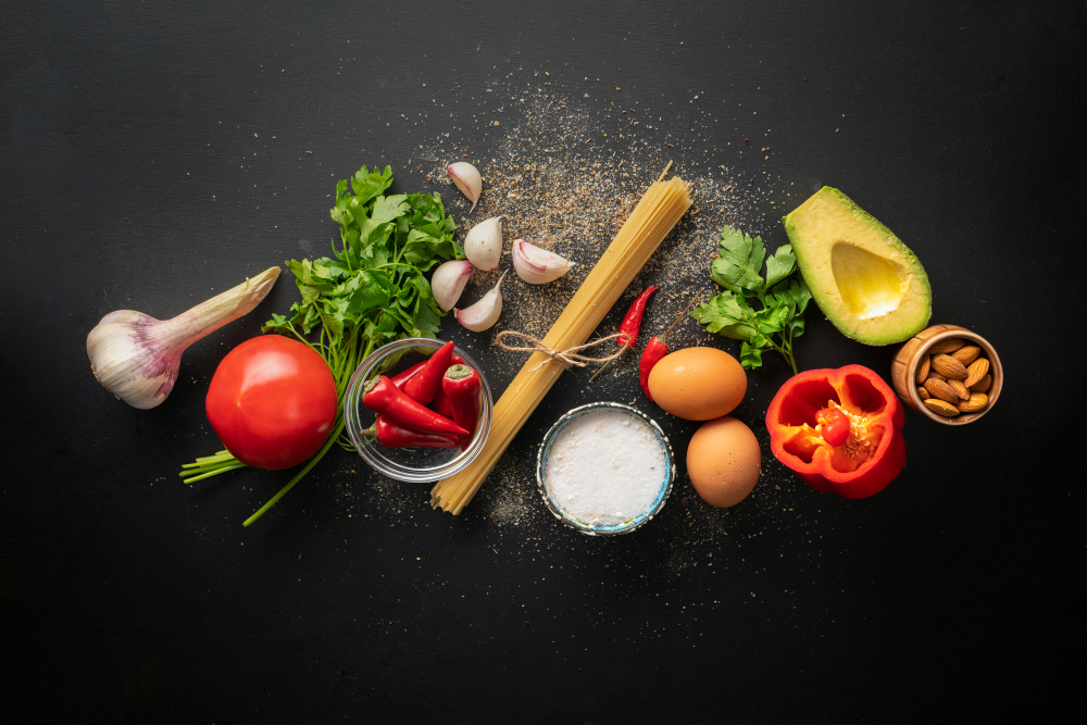 Flat lay of raw ingredients for cooking spaghetti marinara with poached eggs